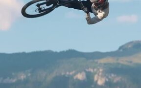 Mountain Bike Free Rider Jumps High Off Slope