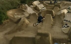 Group of Mountain Bike Riders Jump Over Mud Ramps - Sports - VIDEOTIME.COM