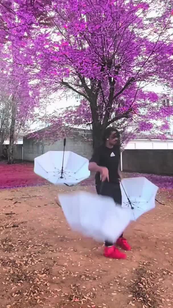 Professional Circus Performer Juggles Umbrellas