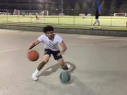 Guy Simultaneously Dribbles Two Basketball