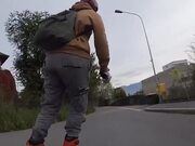 Person Rides on Roller Skates Through City