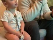 Kid Mimics Dad's Reaction While Watching TV