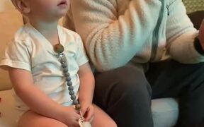 Kid Mimics Dad's Reaction While Watching TV