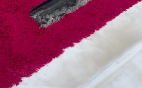 Footage of Water Getting Wiped Off a Red Rug