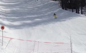 Skier Tumbles After Jumping Off Snow Ramp