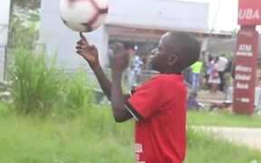 Kid Spins Soccer Ball Over His Finger