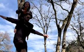 Man With Kids Crosses Slack Line With Them