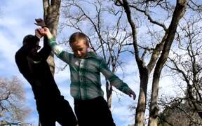 Man With Kids Crosses Slack Line With Them