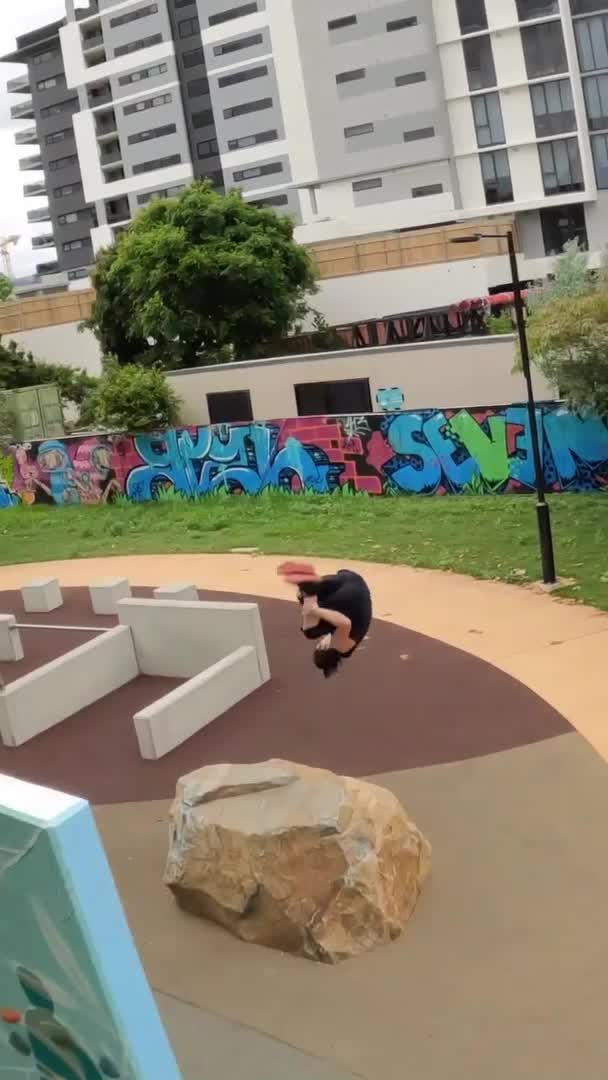Man Parkours Across Obstacle Course in Park