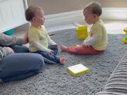 Twin Toddler Playfully Slaps His Identical Brother