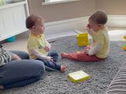Twin Toddler Playfully Slaps His Identical Brother
