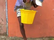 Contortionist Holds a Bucket in Complex Position