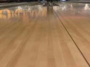 Woman Loses Footing and Falls While Bowling