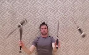 Guy Lays Down on Back and Juggles Knives