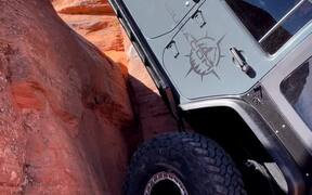 Person Slowly Climbs Huge Rock in His Jeep