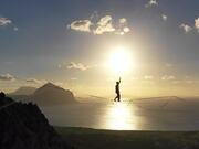Person Does Slacklining Between Two High Cliffs
