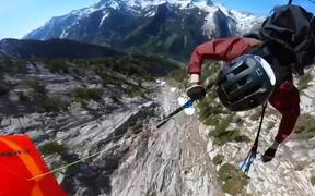 Person Performs Tricks While Speed-Flying Downhill
