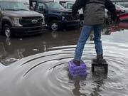 Man Ties Crates to Shoes to Cross Flooded Parking