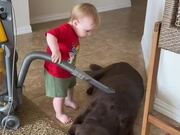 Kid Vacuums Over Dog's Body