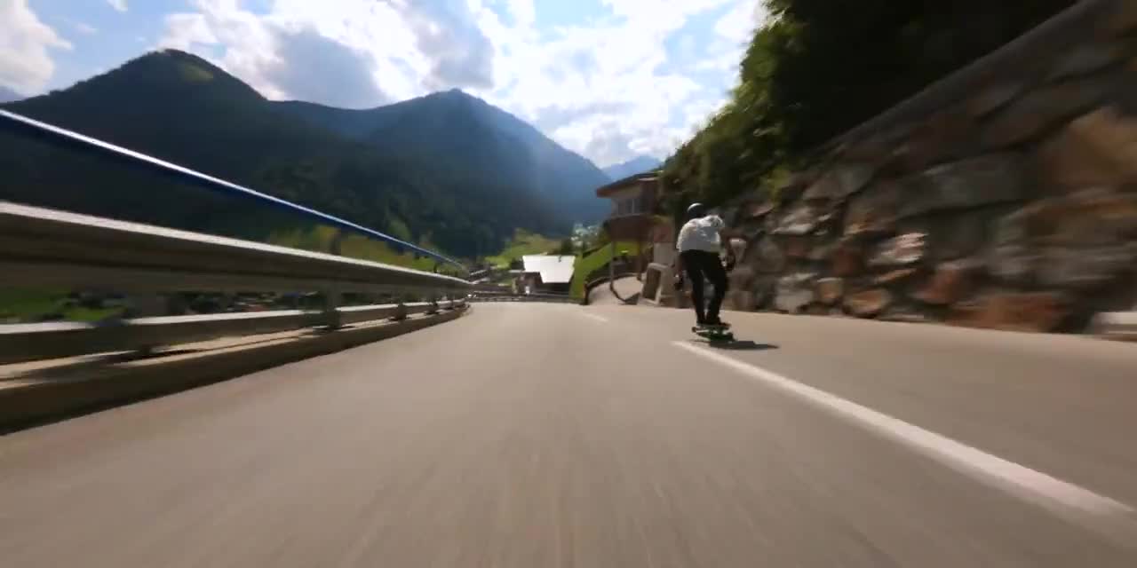 Person Skates on Longboard While Going Downhill