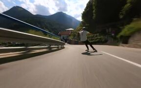 Person Skates on Longboard While Going Downhill