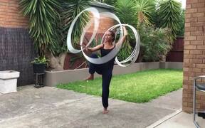 Girl Stands on 1 Leg and Spins Multiple Hula Hoops