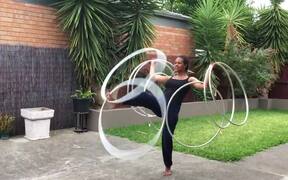 Girl Stands on 1 Leg and Spins Multiple Hula Hoops