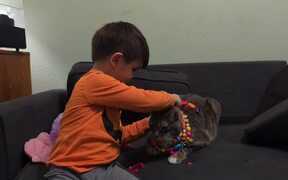 Kid Dresses Up Cat With Necklaces - Animals - Videotime.com