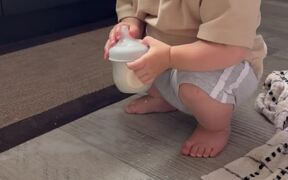 Baby Boy Having Fun at the Expense of Spilled Milk
