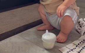 Baby Boy Having Fun at the Expense of Spilled Milk
