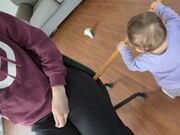 Kid Uses Stick to Help Mom Spin on Revolving Chair