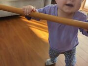 Kid Uses Stick to Help Mom Spin on Revolving Chair