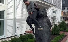 Woman Sitting on Bear Statue Falls Along With it