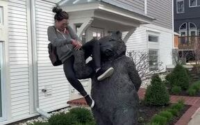 Woman Sitting on Bear Statue Falls Along With it