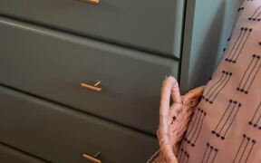 Woman Refurbishes Old Dresser