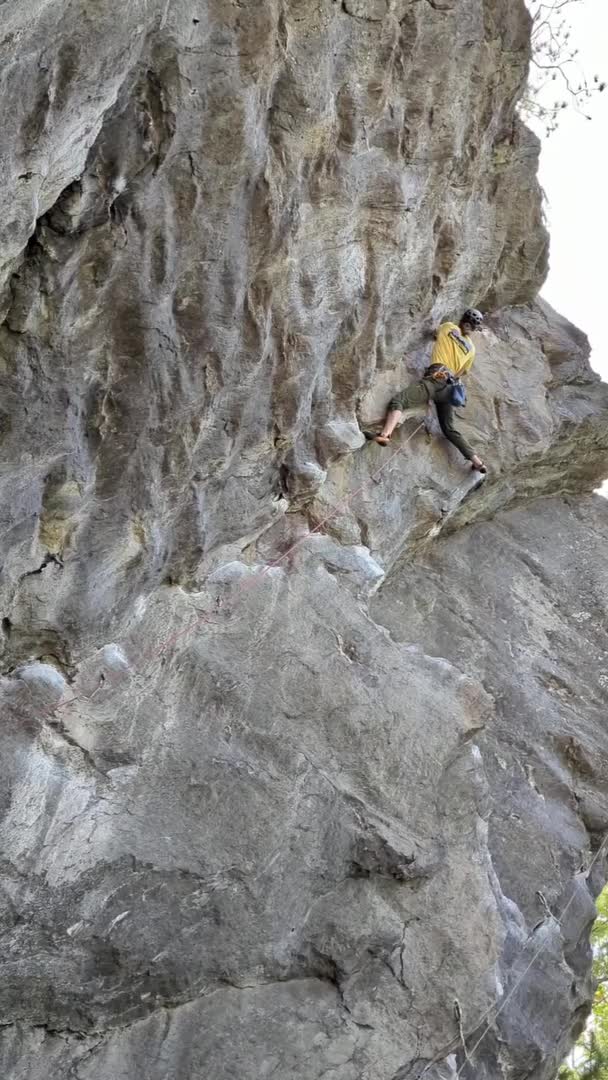 Man Loses Grip While Climbing Rock Face and Falls