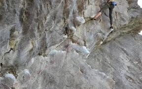 Man Loses Grip While Climbing Rock Face and Falls