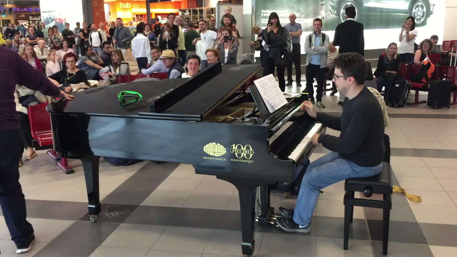 Duo Sings and Plays Piano for Crowd in Airport