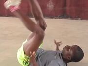 Kid Juggles Football With Head and Sole