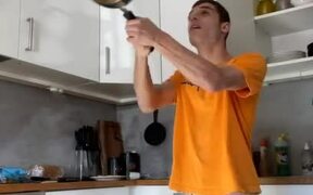 Guy Bangs Head While Flipping Pancake