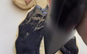 Person Decorates Wedding Themed Cookie