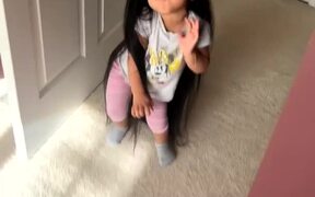 Kid Acts Funny and Poses While Wearing Mom's Wig