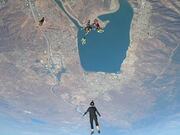 Group Skydives Out of Airplane and Performs Trick
