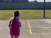 Little Girl Practices Basketball With Dog