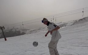 Skier Juggles Football While Performing Tricks