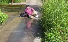 Guy Carrying Golf Bag Across Stream Slips &Falls
