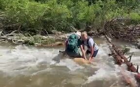 Woman and Dog Attempt to Cross Fast Flowing Stream