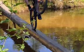 Guy Falls in Water While Riding His Bike