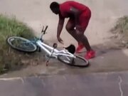 Guy Falls Off Bike While Riding Down Sloped Road