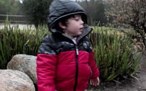 Kid Plays Outside on Rainy Day